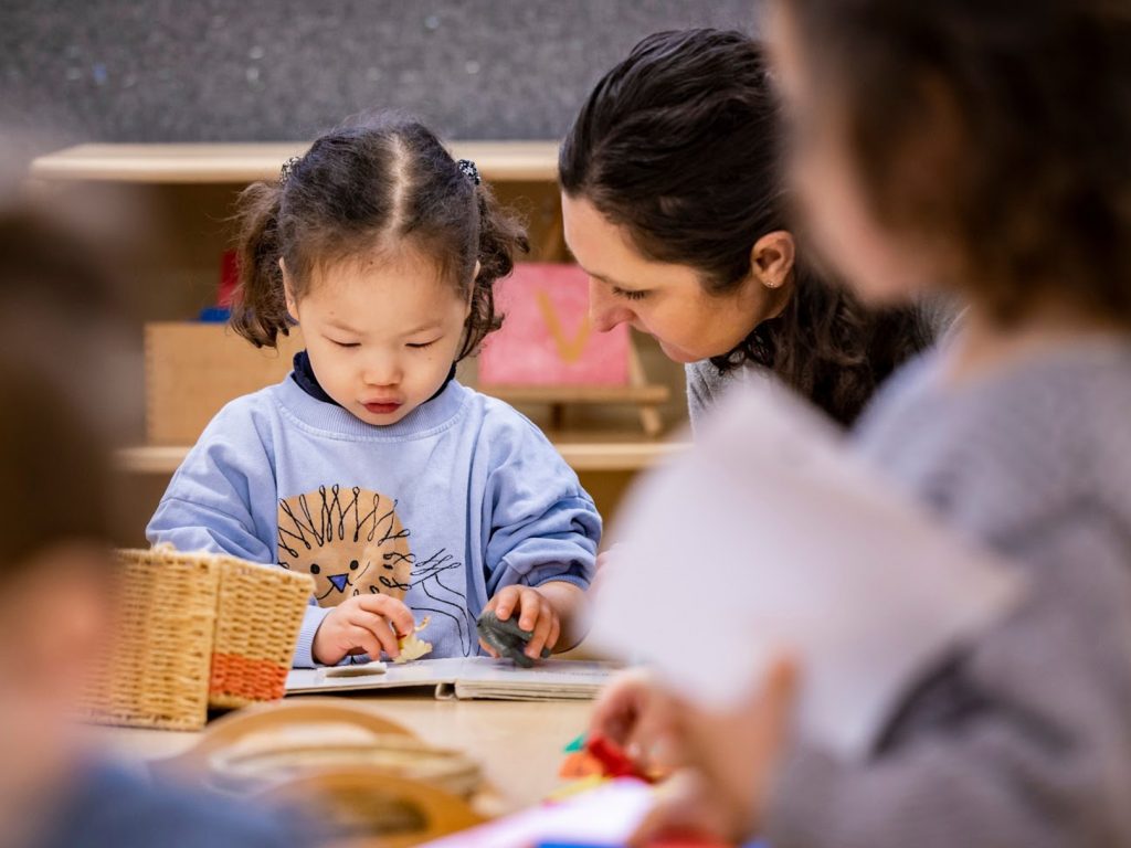 teacher helping a child read