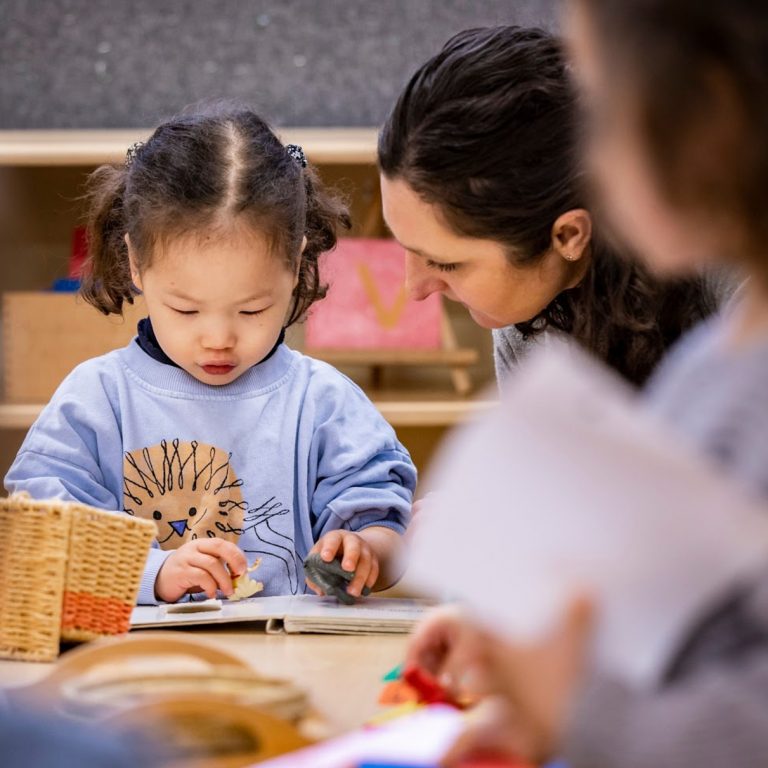 teacher helping a child read