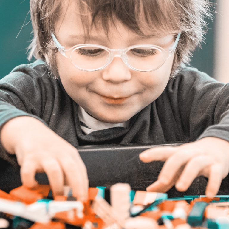 child sifting through lego