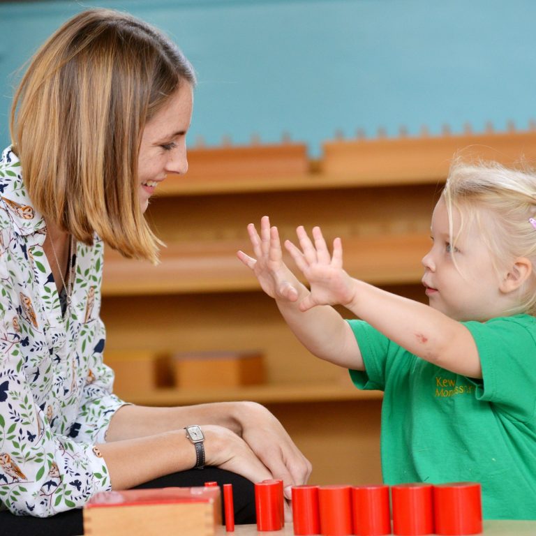 girl showing her hands to her teacher